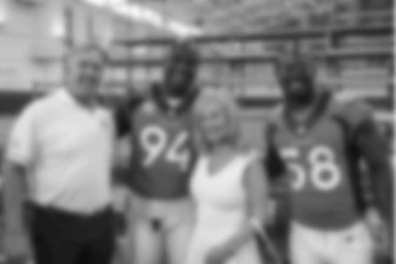 Executive Vice President of Football Operations/General Manager John Elway, outside linebacker DeMarcus Ware (94), Annabel Bowlen, outside linebacker Von Miller (58) at the Broncos' 2016 team photo picture day at the Pat Bowlen Fieldhouse.
