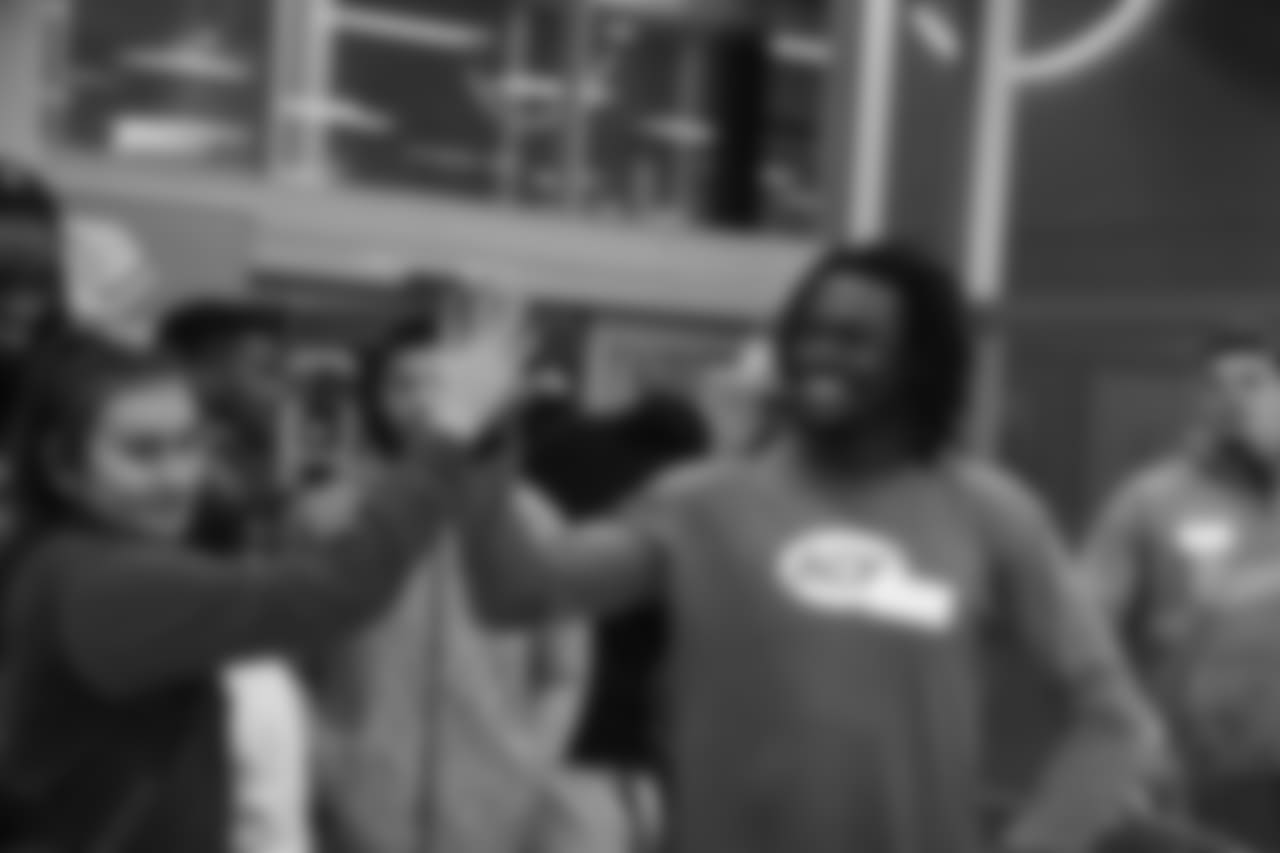 Isaac Yiadom high-fives a participant during Will Parks' shopping spree for the Boys & Girls Club of Metro Denver on Dec. 3, 2018