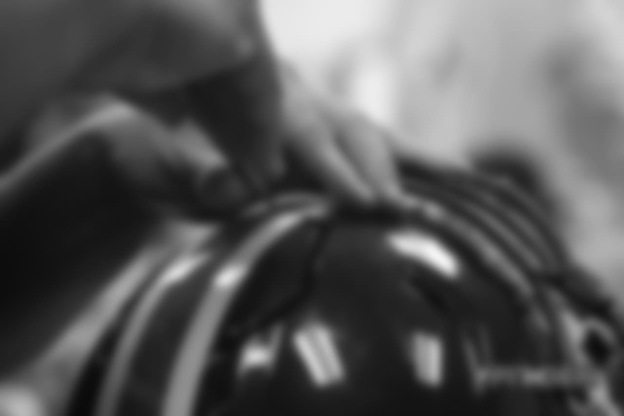 Inside the Broncos' equipment room as staffers transition helmets to the team's Color Rush set, applying new decals and throwback logos for the team's Week 12 game.
