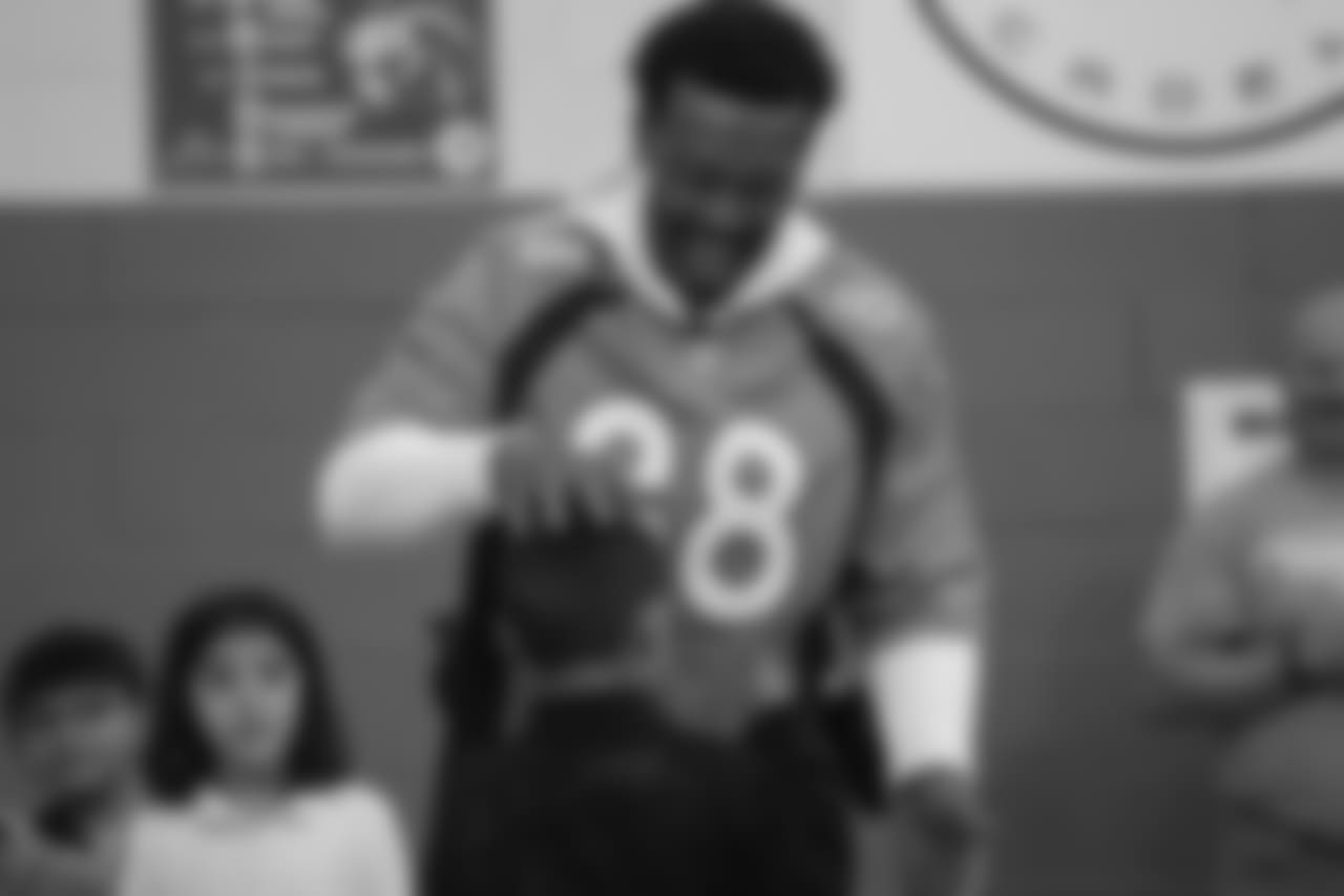 Demaryius Thomas plays rock, paper, scissors at a Playworks recess visit (alongside CarMax volunteers) with first-, second- and third-grade students at Greenwood Academy on October 9, 2018.