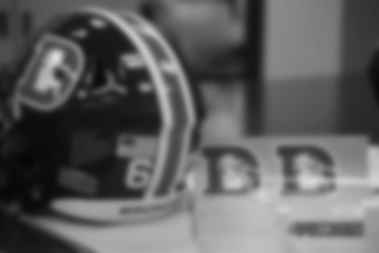Inside the Broncos' equipment room as staffers transition helmets to the team's Color Rush set, applying new decals and throwback logos for the team's Week 12 game.