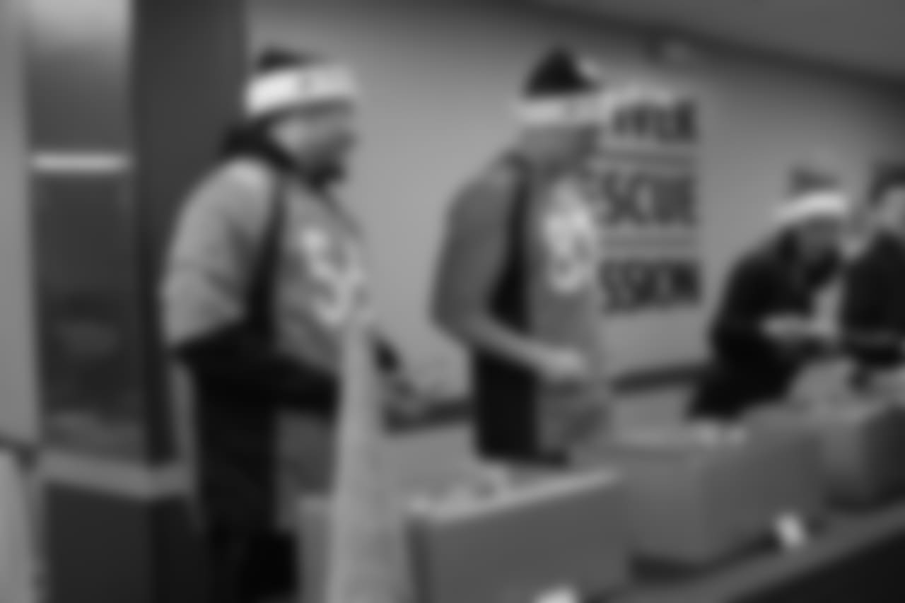 Shane Ray and Matt LaCosse serve dinner at the Denver Rescue Mission's 19th annual holiday party.