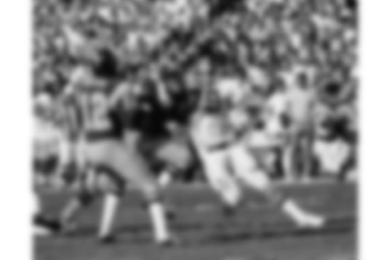 Defensive end Barney Chavous (79) pressures San Diego Chargers quarterback James Harris (12) during an NFL game in San Diego, Nov. 13, 1977. The Broncos defeated the Chargers 17-14. (AP Photo/NFL Photos)