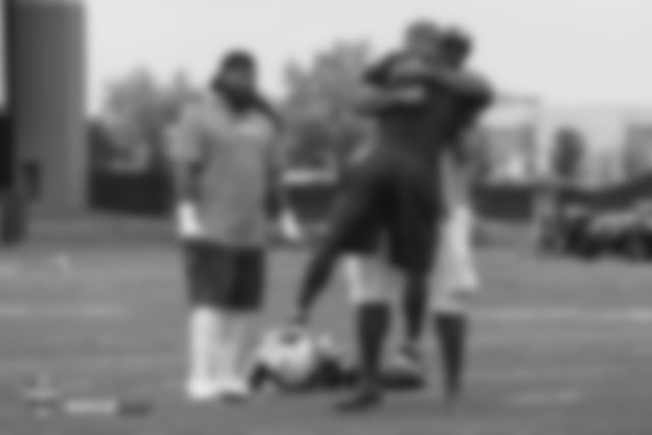 Former Bronco Kevin Vickerson lifts up Assistant Strength and Conditioning Coach Anthony Lomando with a big hug during the 10th day of training camp on August 8, 2018, at UCHealth Training Center.