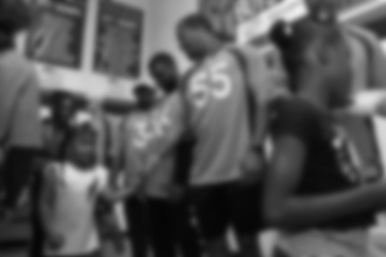 Outside linebacker Bradley Chubb (55) shakes hands with a young girl at the Denver Broncos Boys & Girls Club at the Broncos' third annual Rookie Community Service Day on June 11, 2018.