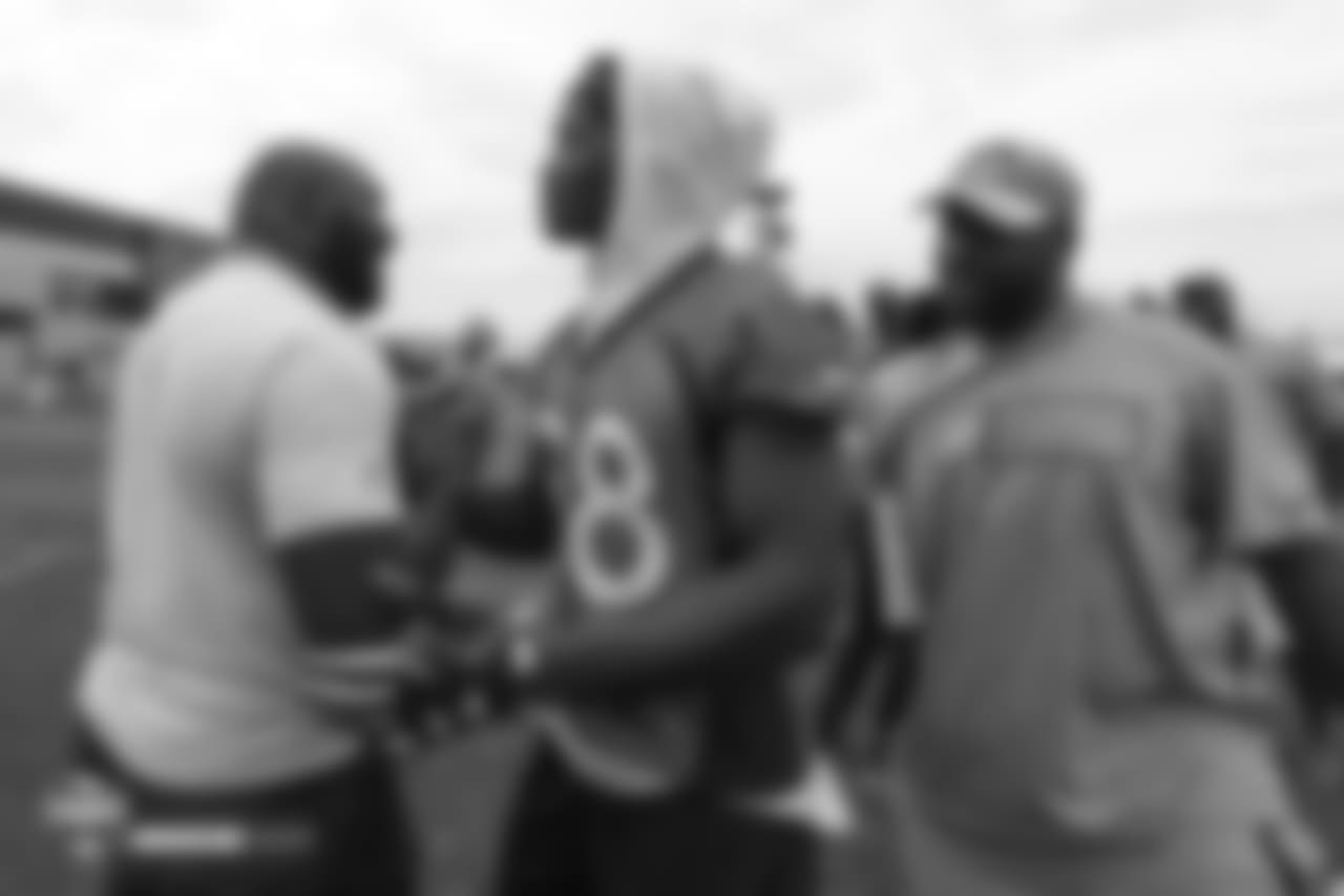 Wide receiver Demaryius Thomas (88) greets former Bronco Reuben Droughns during the 10th day of training camp on August 8, 2018, at UCHealth Training Center.