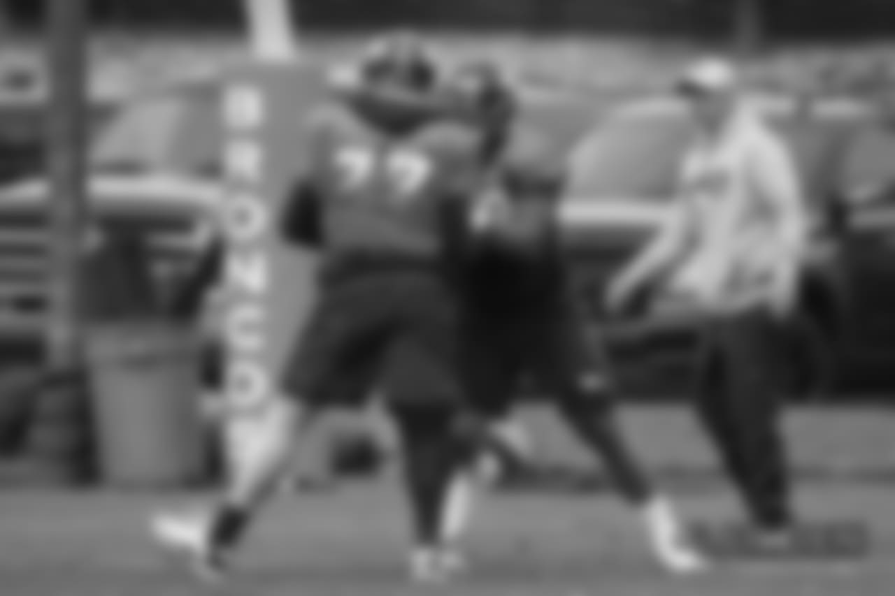 Billy Turner and Elijah Wilkinson with Offensive Line-Tackles Coach Chris Strausser at practice at UCHealth Training Center on October 11, 2018.