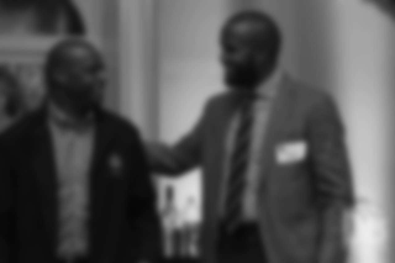 Champ Bailey greets Hall of Famer Darrell Green, who was his teammate when he started his career in Washington, at the Pro Football Hall of Fame's Celebration of Excellence Reception in Atlanta on January 31, 2019.