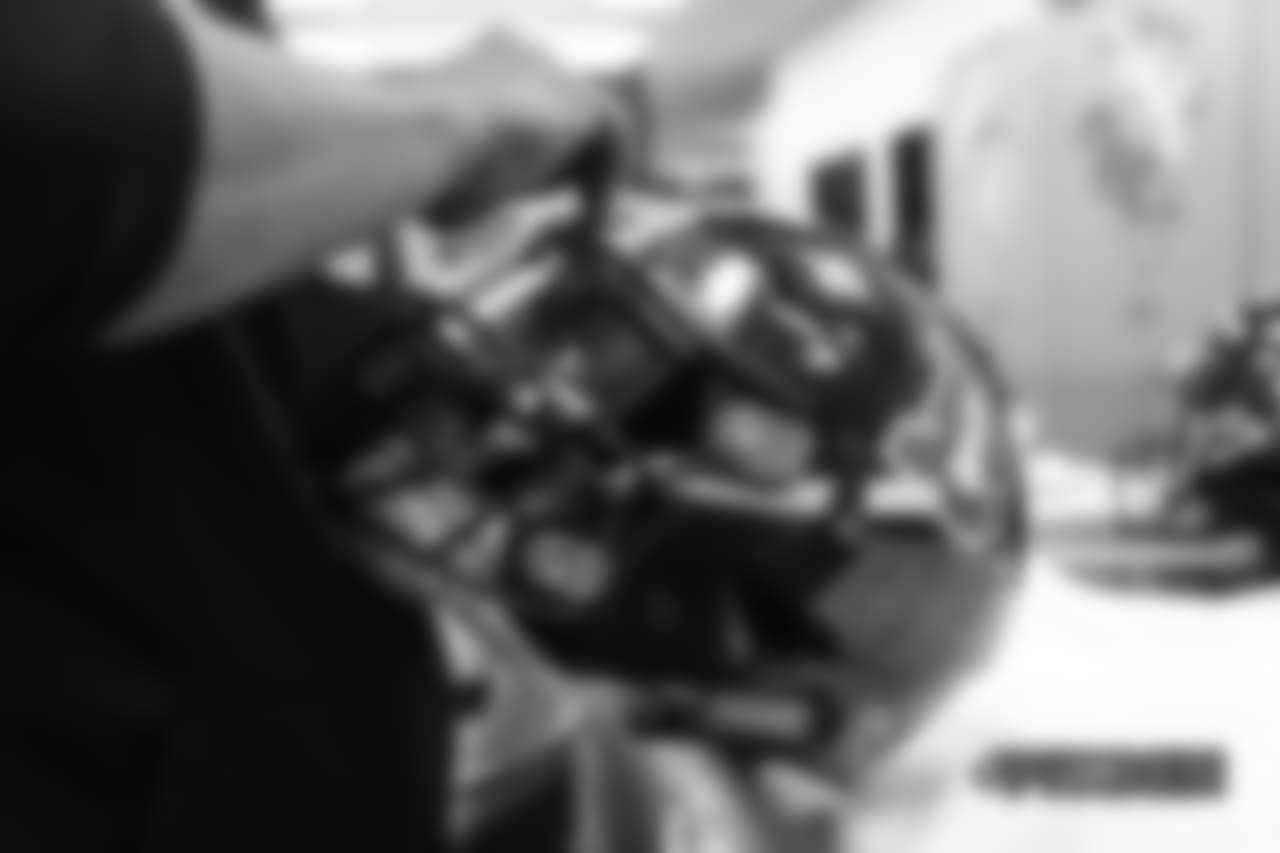 Inside the Broncos' equipment room as staffers transition helmets to the team's Color Rush set, applying new decals and throwback logos for the team's Week 12 game.