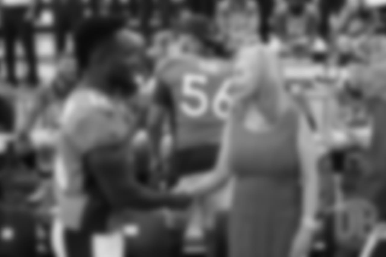 Isaiah McKenzie greets Annabel Bowlen at team photo day at UCHealth Training Center on September 15, 2018.