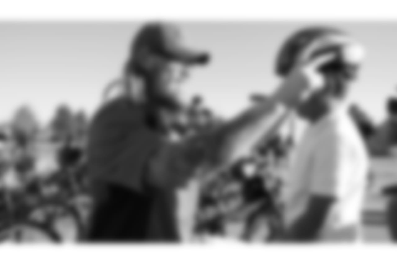Andreas Knappe adjusts a helmet during a bike distribution at Green Valley Elementary School in Denver on December 18, 2018.