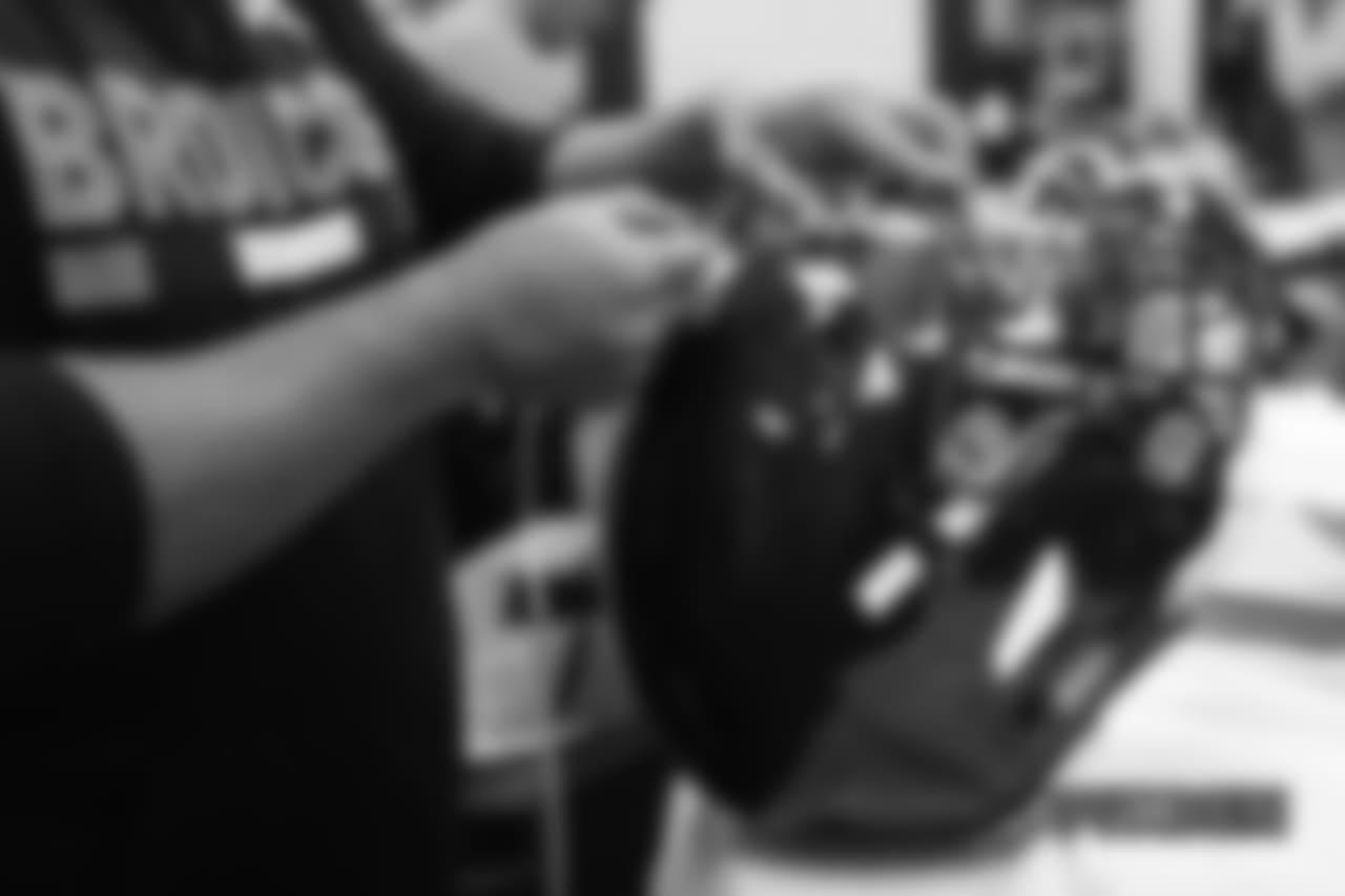 Inside the Broncos' equipment room as staffers transition helmets to the team's Color Rush set, applying new decals and throwback logos for the team's Week 12 game.