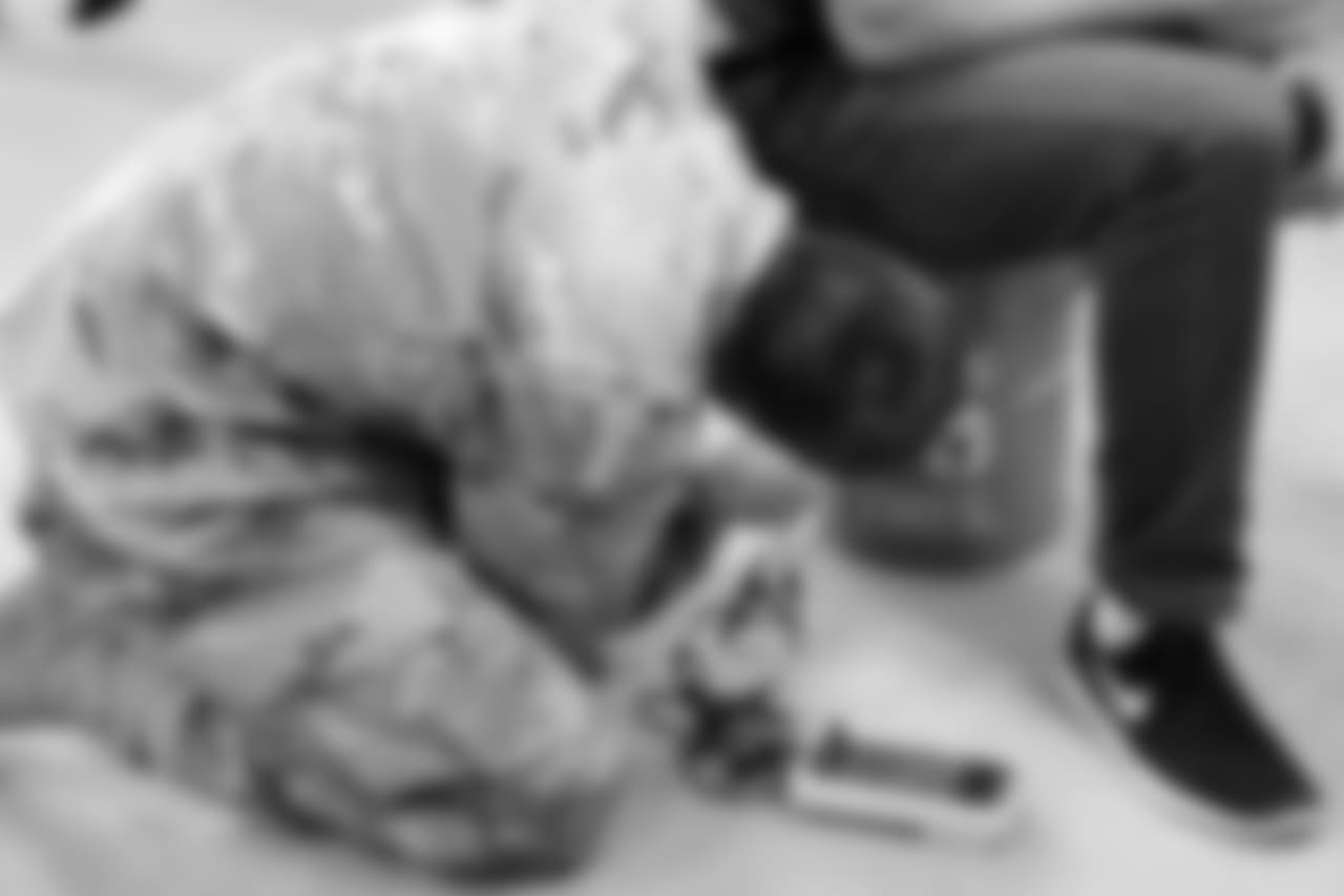 A member of the the 71st EOD Company shows how to defuse a 'bomb' with a citizen on top of it.