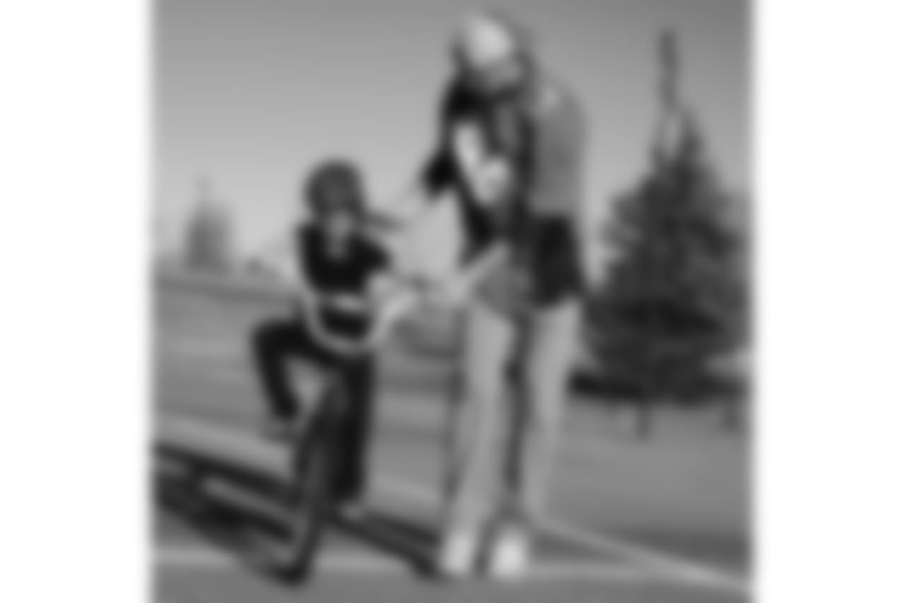 Tim Semisch helps a bike rider during a bike distribution at Green Valley Elementary School in Denver on December 18, 2018.