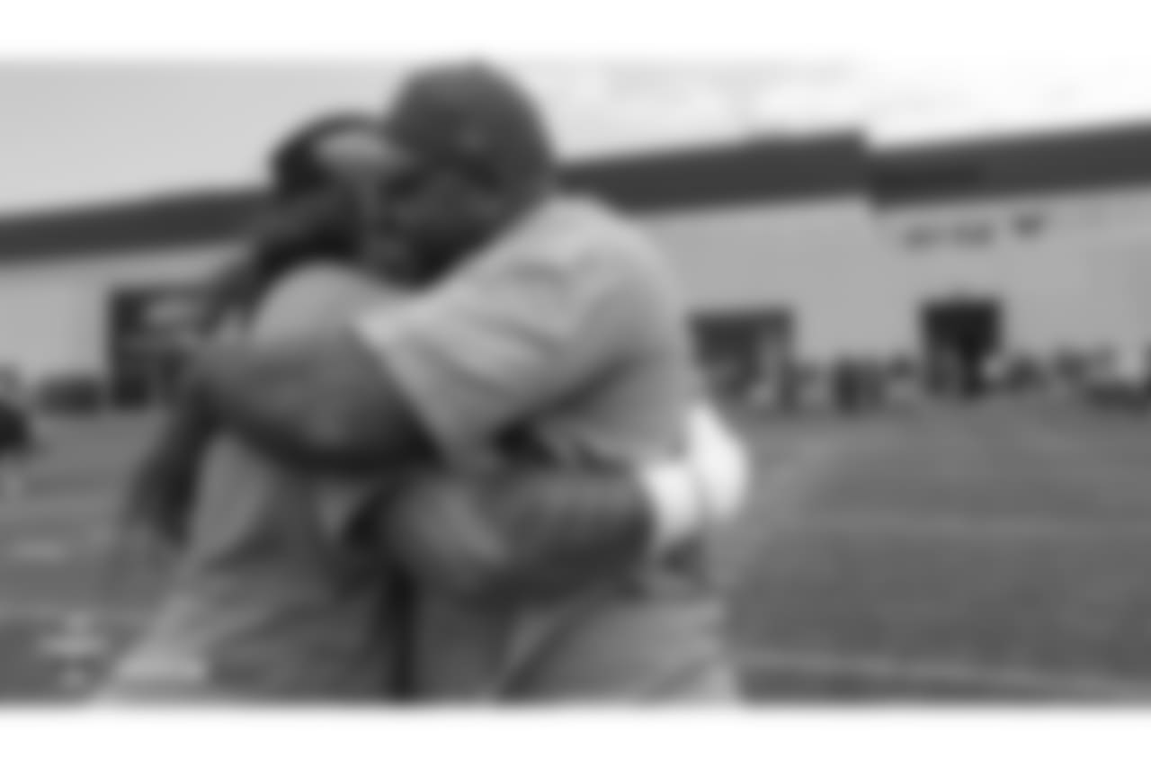Nose tackle Domata Peko Sr. (94) hugs former Bronco Kevin Vickerson during the 10th day of training camp on August 8, 2018, at UCHealth Training Center. Vickerson and Peko were college teammates at Michigan State.