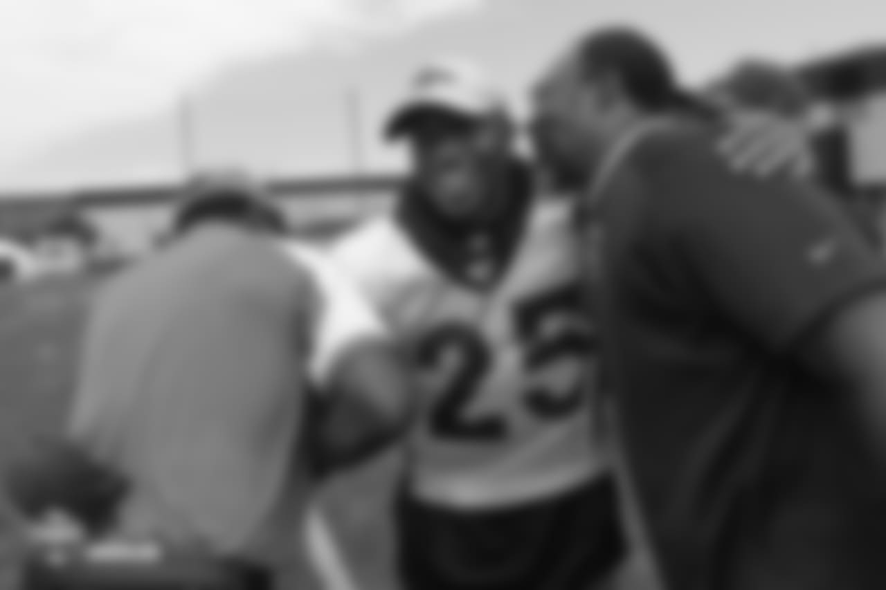 cornerback Chris Harris Jr. (25) greets Ring of Fame former safety Billy Thompson and a Broncos alumnus during the 10th day of training camp on August 8, 2018, at UCHealth Training Center.