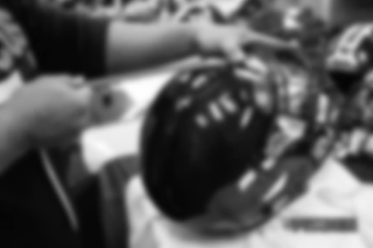 Inside the Broncos' equipment room as staffers transition helmets to the team's Color Rush set, applying new decals and throwback logos for the team's Week 12 game.