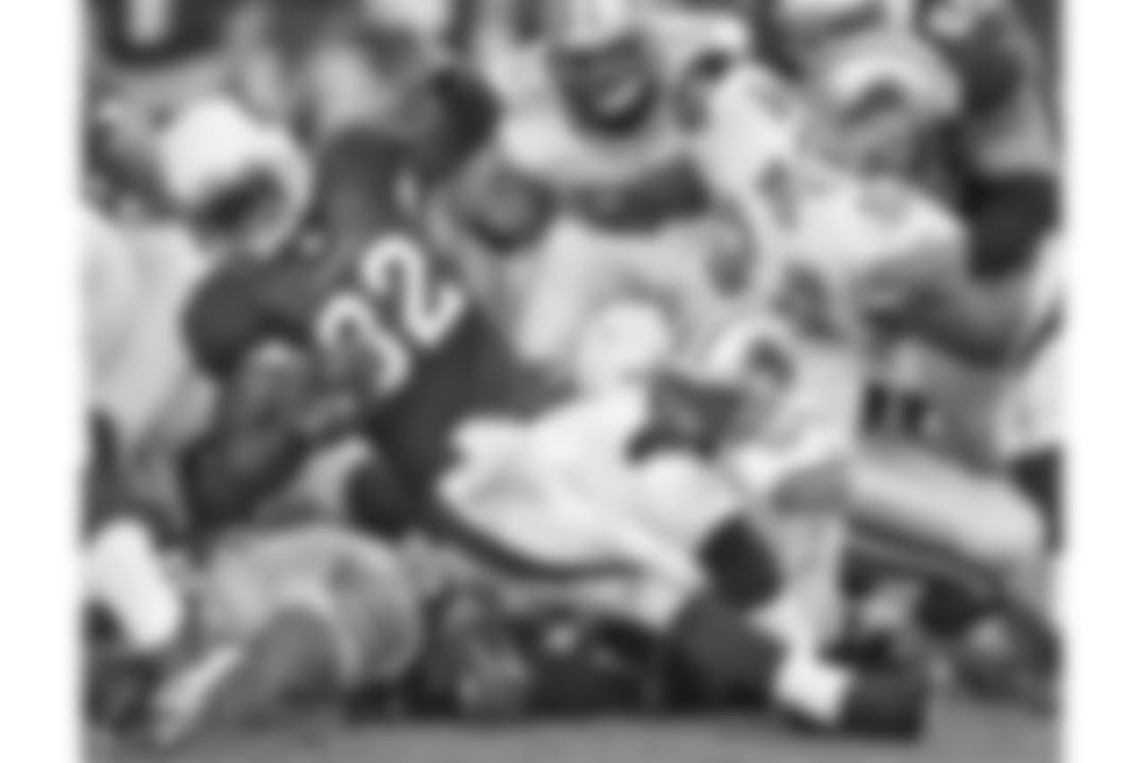 Arizona Cardinals' Edgerrin James (32) picks up a short gain as Detroit Lions' Teddy Lehman (54) pulls him down during the second quarter of an NFL football game Sunday, Nov. 19, 2006, in Glendale, Ariz.