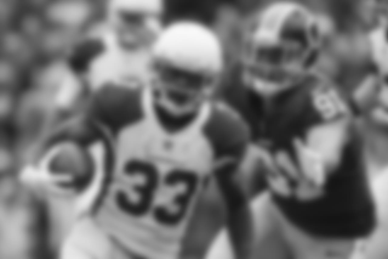 Arizona Cardinals running back Kerwynn Williams (33) carries the ball as Washington Redskins outside linebacker Ryan Kerrigan (91) chases him during the first half of an NFL football game in Landover, Md., Sunday, Dec 17, 2017.