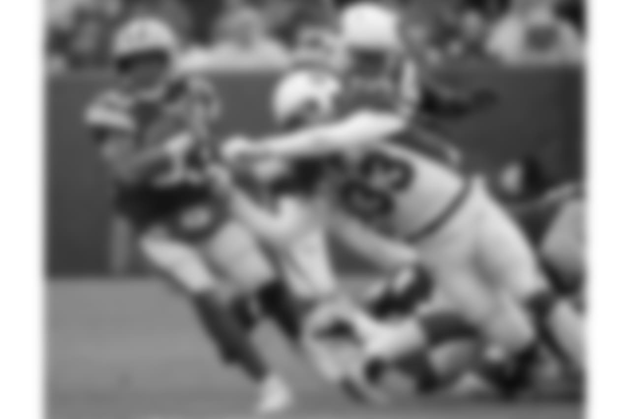 Green Bay Packers running back Aaron Jones is hit during a run by Arizona Cardinals defensive back Tre Boston during the second half of an NFL football game Sunday, Dec. 2, 2018, in Green Bay, Wis.