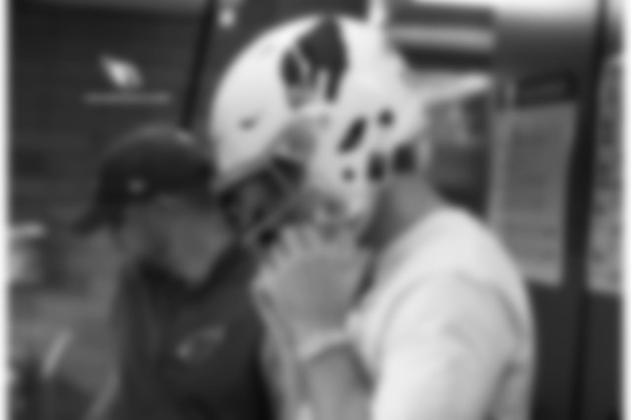QB Josh Rosen tries on a helmet