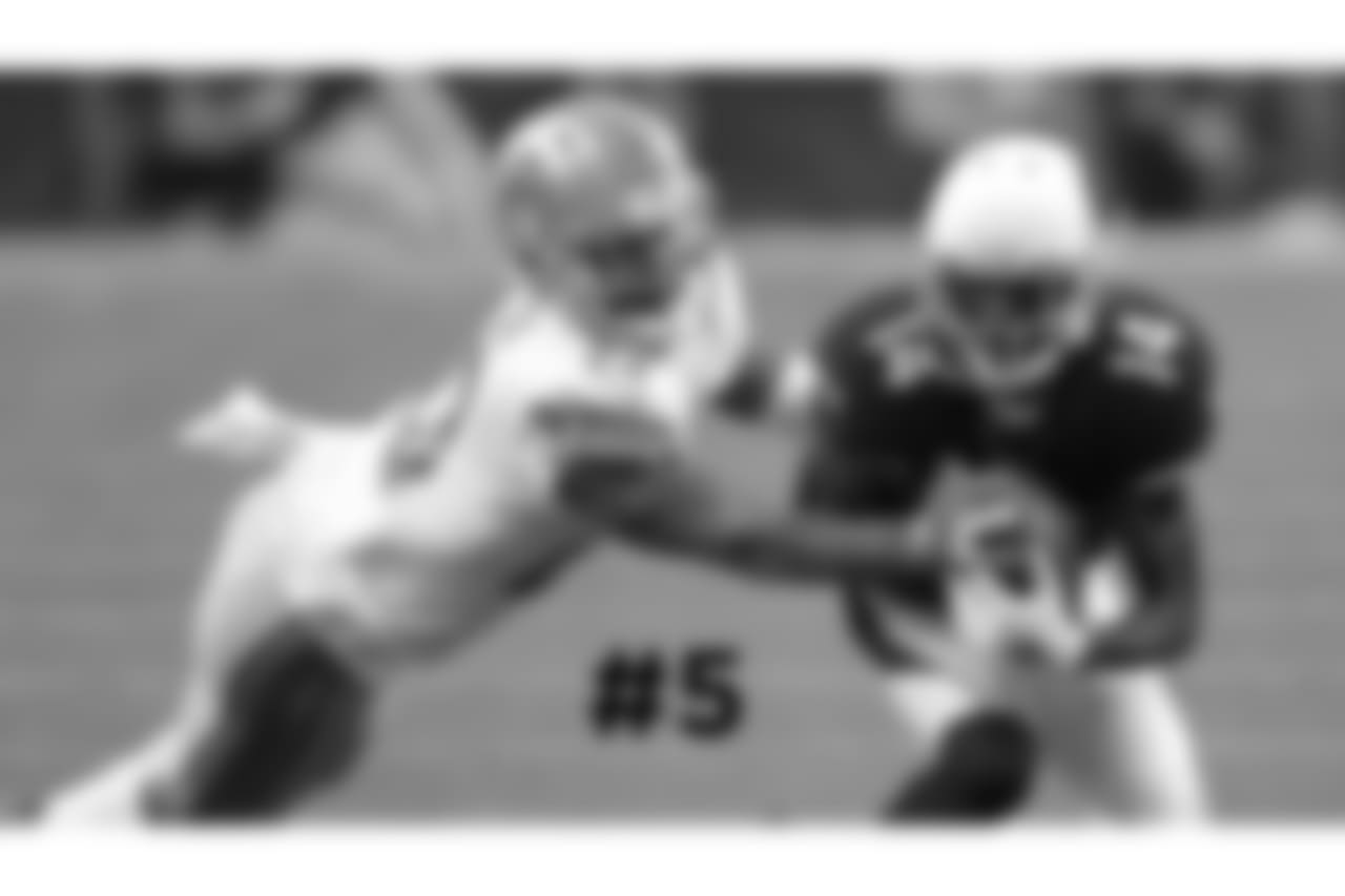 5\. Cardinals wide receiver J.J. Nelson pulls in a pass as Lions cornerback Darius Slay defends