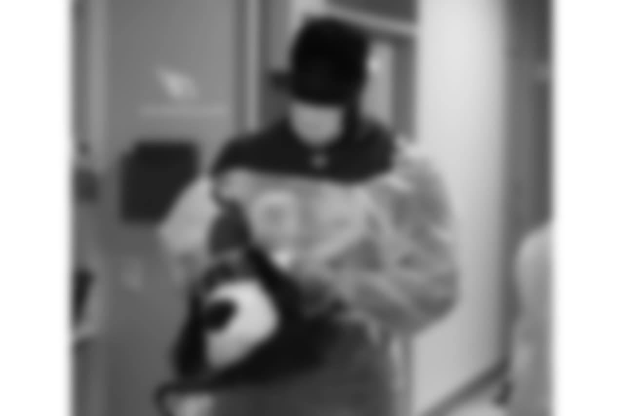 Frostee Rucker signs a dog