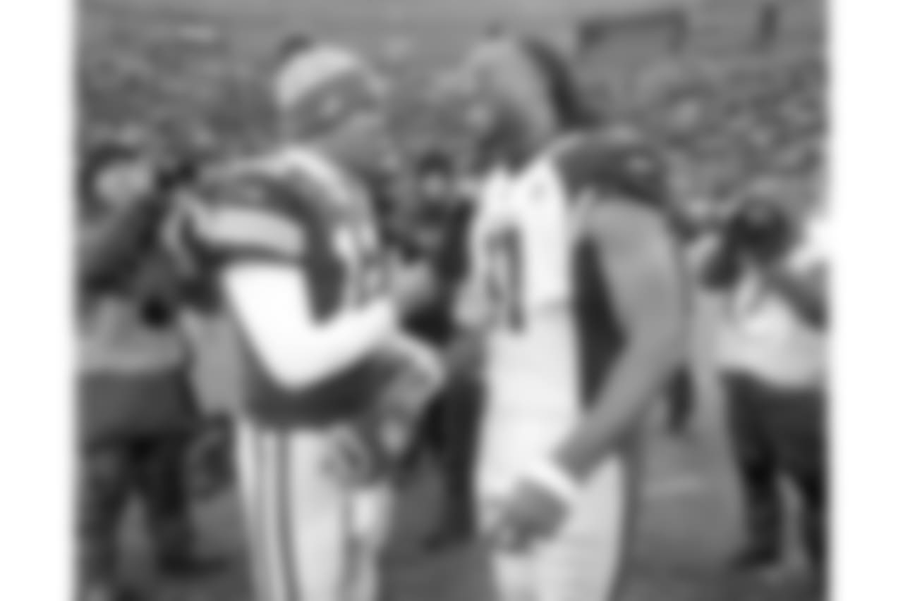 Green Bay Packers quarterback Aaron Rodgers and Arizona Cardinals wide receiver Larry Fitzgerald talk out on the field following the conclusion of an NFL football game Sunday, Dec. 2, 2018, in Green Bay, Wis. Arizona won 20-17.
