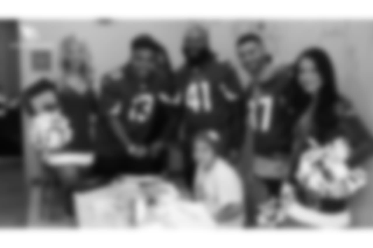 WR Christian Kirk (13), S Antoine Bethea (41) and RB D.J. Foster snap a photo with a patient and the Cardinals cheerleaders