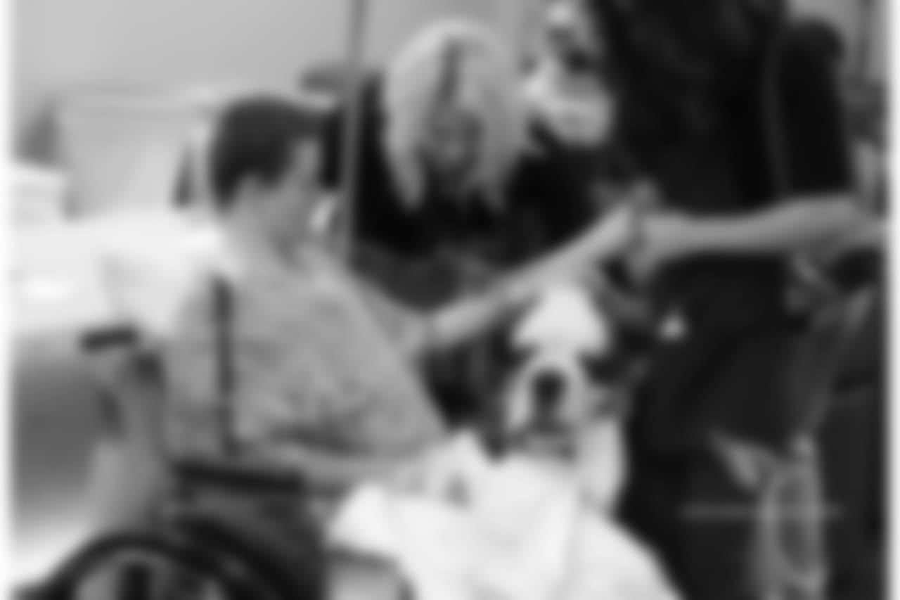 Nicole Bidwill helps a patient pet Barney