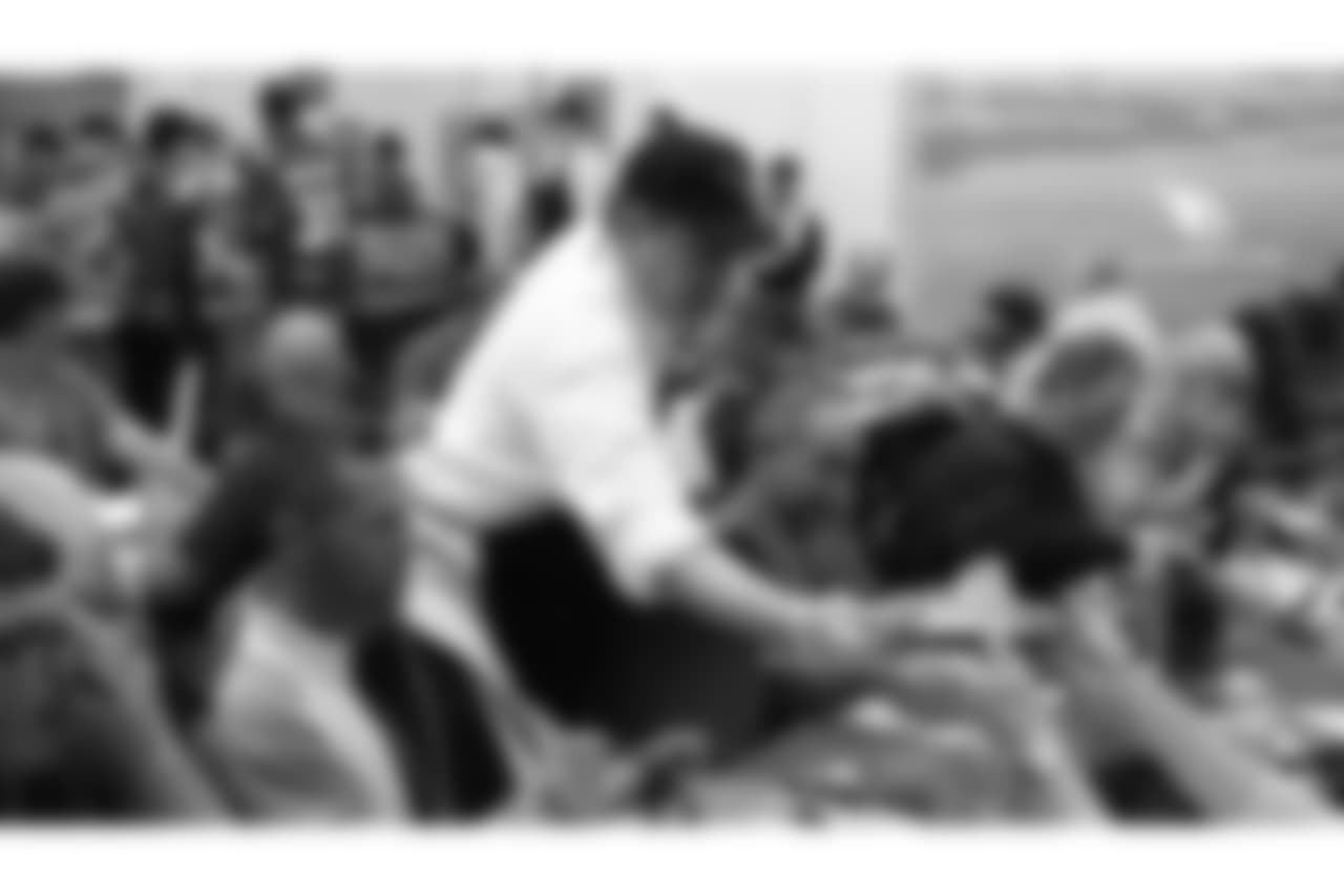 Team president Michael Bidwill hands out a dinner