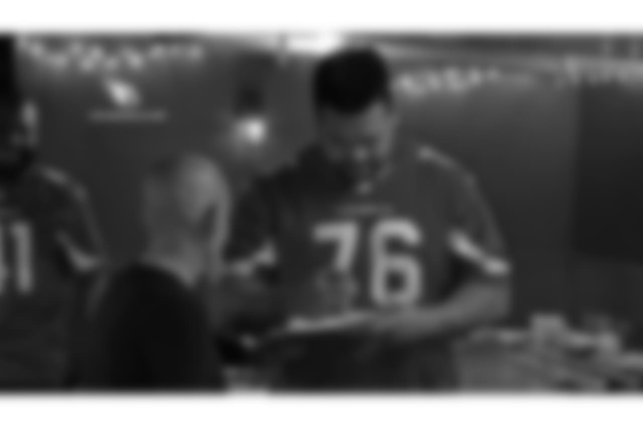 G Mike Iupati signs an autograph