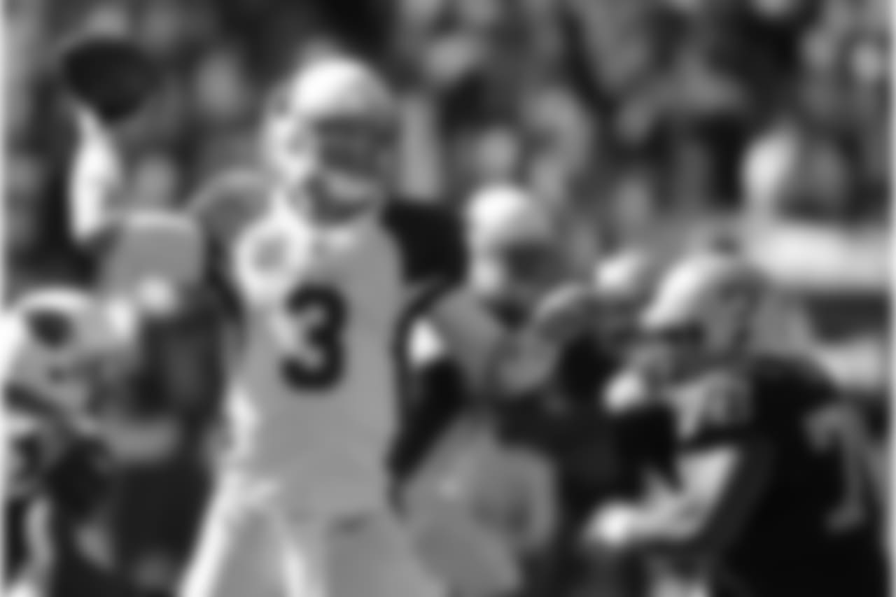 Arizona Cardinals quarterback Carson Palmer (3) passes against the Oakland Raiders during the first quarter of an NFL football game in Oakland, Calif., Sunday, Oct. 19, 2014.