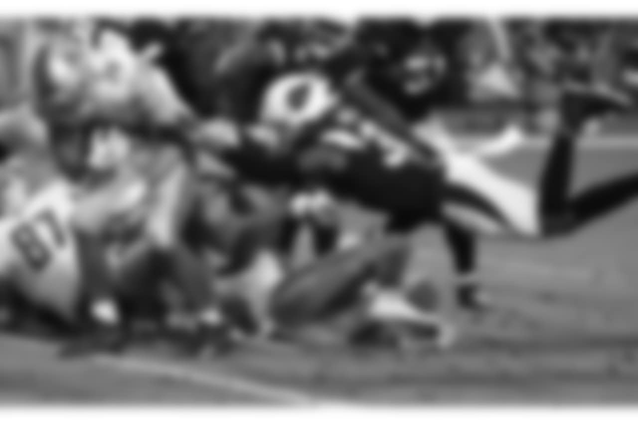 Detroit Lions running back Zach Zenner (34) scores a touchdown as Arizona Cardinals defensive back David Amerson defends during the second half of NFL football game, Sunday, Dec. 9, 2018, in Glendale, Ariz.