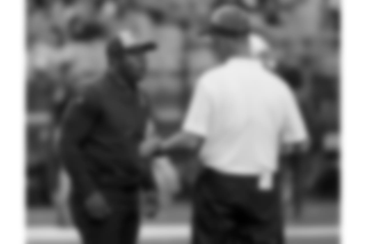 Arizona Cardinals offensive coordinator Mike McCoy talks with Denver Broncos head coach Vance Joseph prior to an NFL football game , Thursday, Oct. 18, 2018, in Glendale, Ariz.