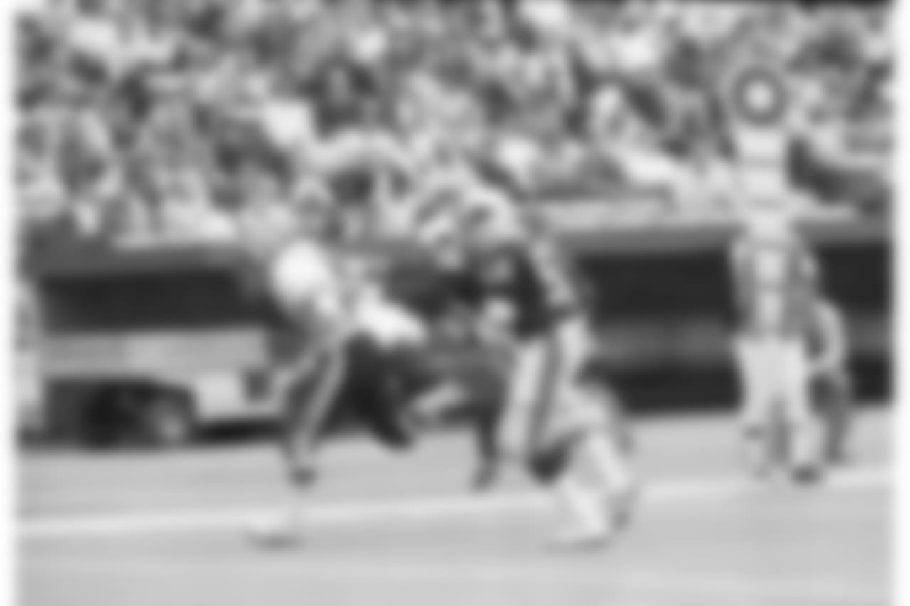 Washington Redskins running back John Riggins is followed into the end zone by St. Louis Cardinals Lee Nelson (38) and Charlie Baker (52) during the first quarter of their game in St. Louis, Oct. 9, 1983. Riggins touchdown run was for 17 yards.
