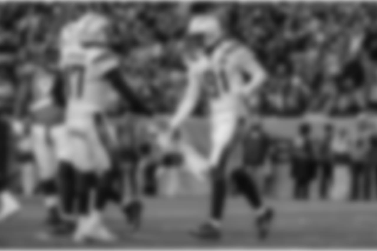 Philip Rivers and Mike Williams slap hands after Williams' scores a touchdown during the Week 17 contest against the Denver Broncos.
