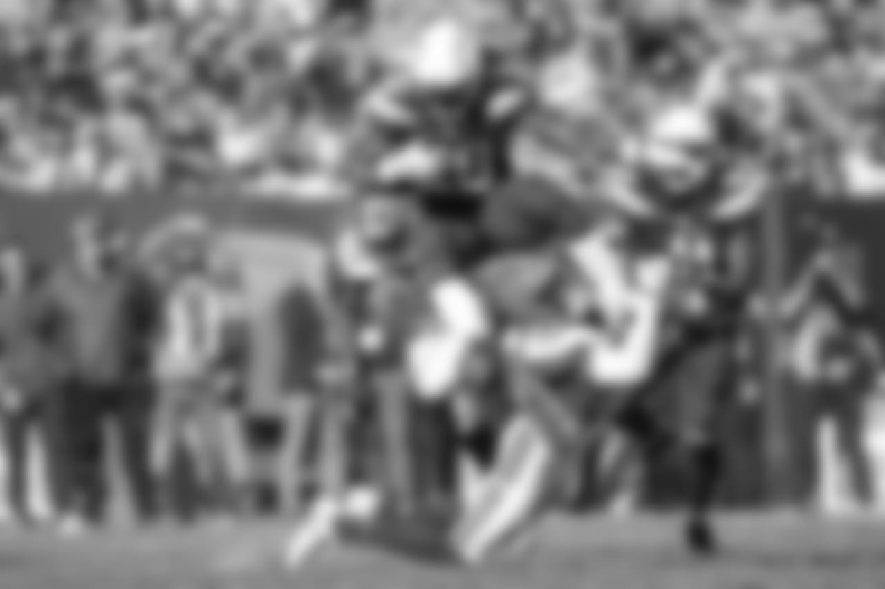 Melvin Gordon leaps over defenders during the Week 6 matchup against the Browns.