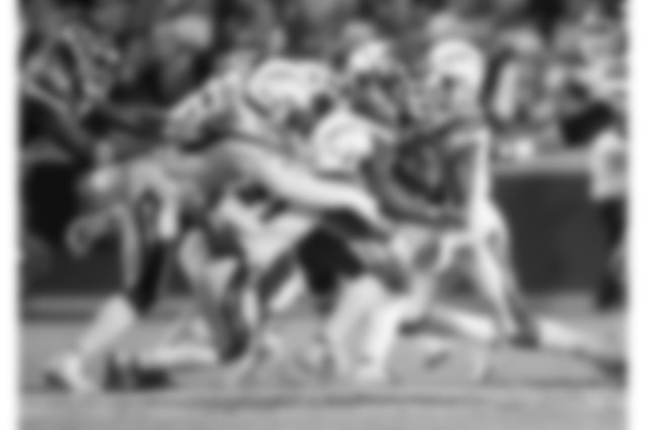 Adrian Phillips and Derwin James make a tackle vs. the Kansas City Chiefs on Thu. Dec. 13, 2018 at Arrowhead Stadium.