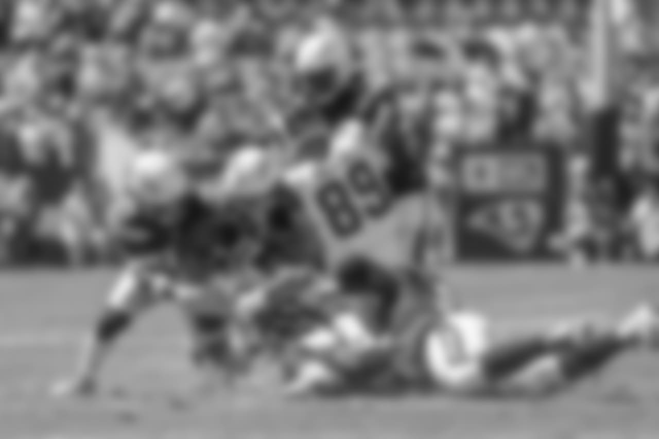 Chargers defenders stop run during the Bolts' matchup against the LA Rams at the LA Memorial Coliseum.