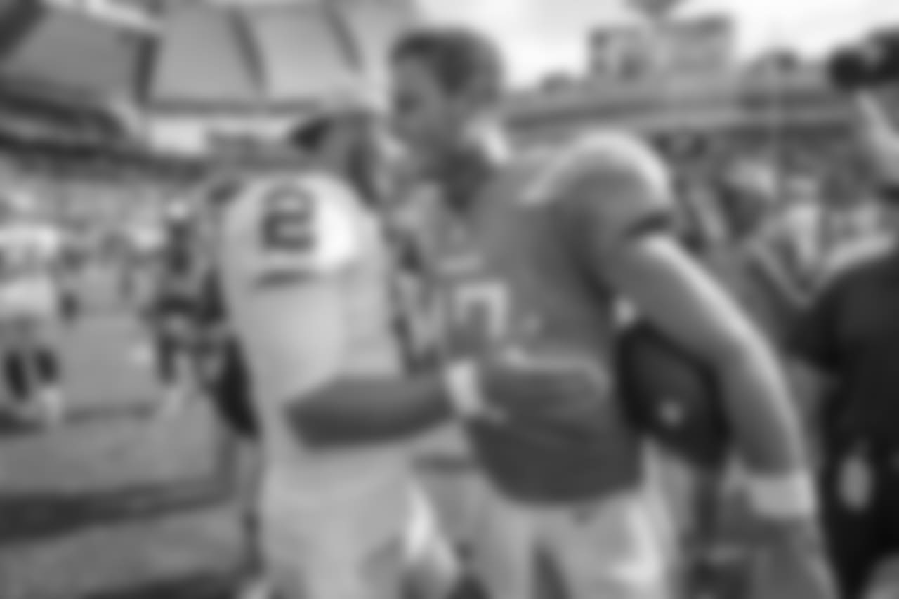 Derek Carr and Philip Rivers greet each other postgame after the Bolts defeated the Raiders 26-10 during Week 5.