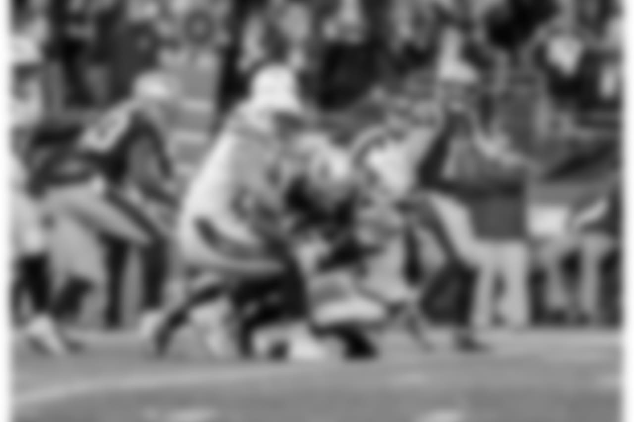Kyle Emanuel and Rayshawn Jenkins tackle RB Sony Michel during the Divisional Round matchup against the New England Patriots at Gillette Stadium.