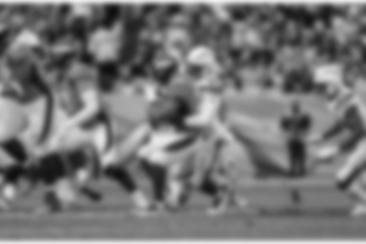 Isaac Rochell hits Broncos RB Royce Freeman during the Week 17 contest against the Denver Broncos.