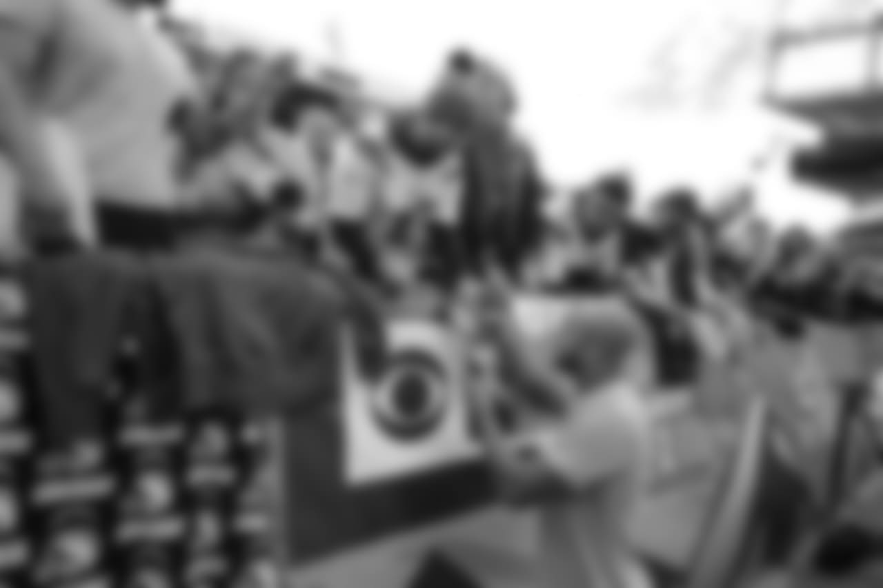 Austin Ekeler signs autographs for fans before the Week 17 contest against the Denver Broncos.