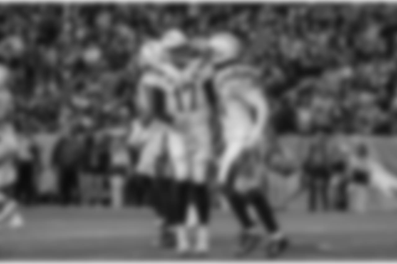 Philip River and Mike Williams celebrate Williams' touchdown during the Week 17 contest against the Denver Broncos.