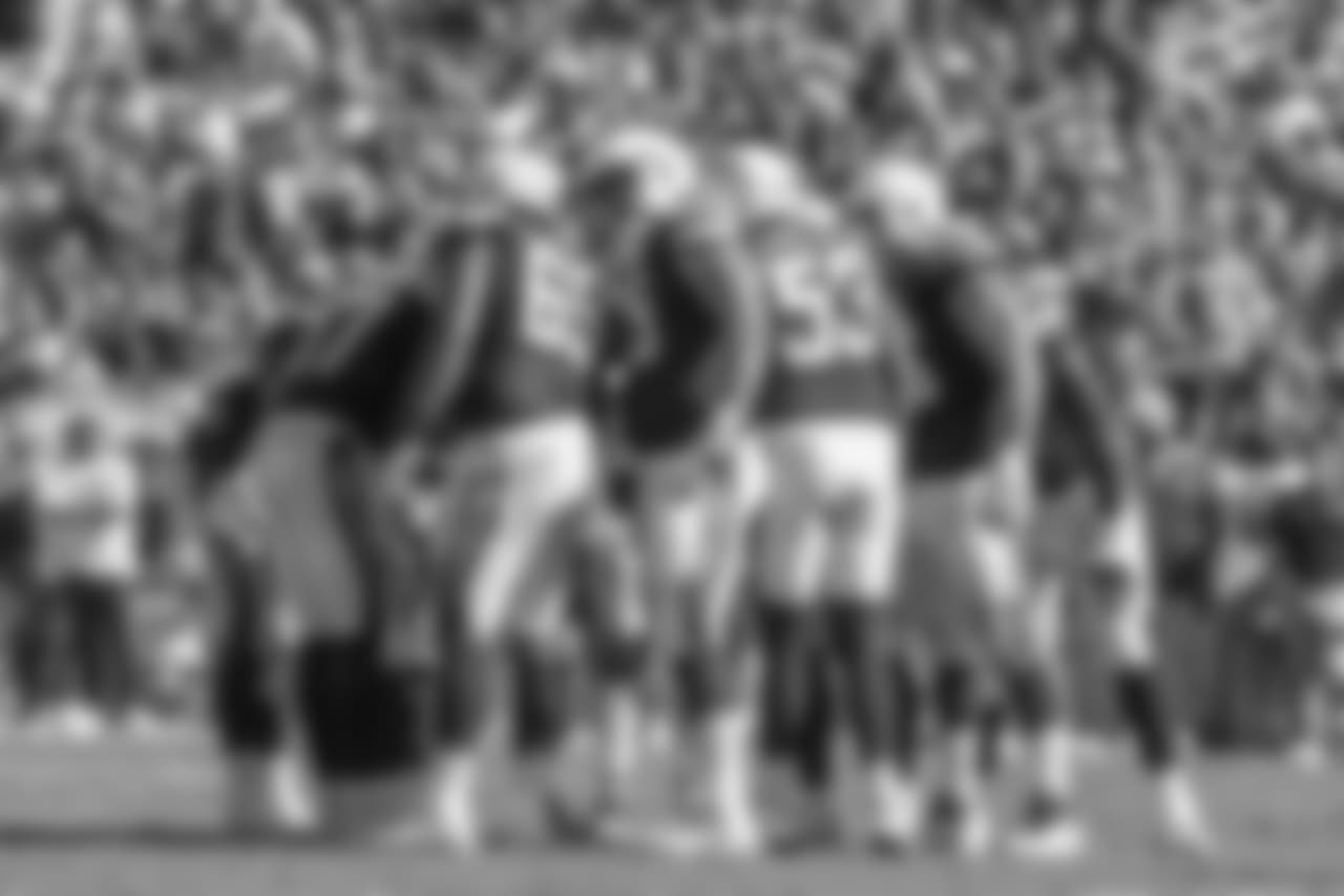 The team huddles on the field during the Bolts' matchup against the LA Rams at the LA Memorial Coliseum.