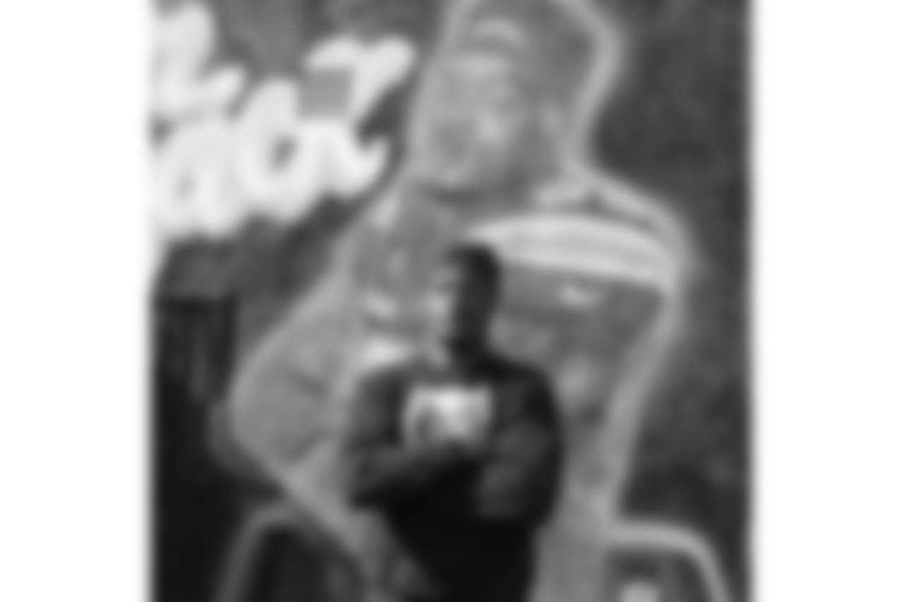 Derwin James poses in front of his very own mural in LA created by iconic muralist Jonas Never.