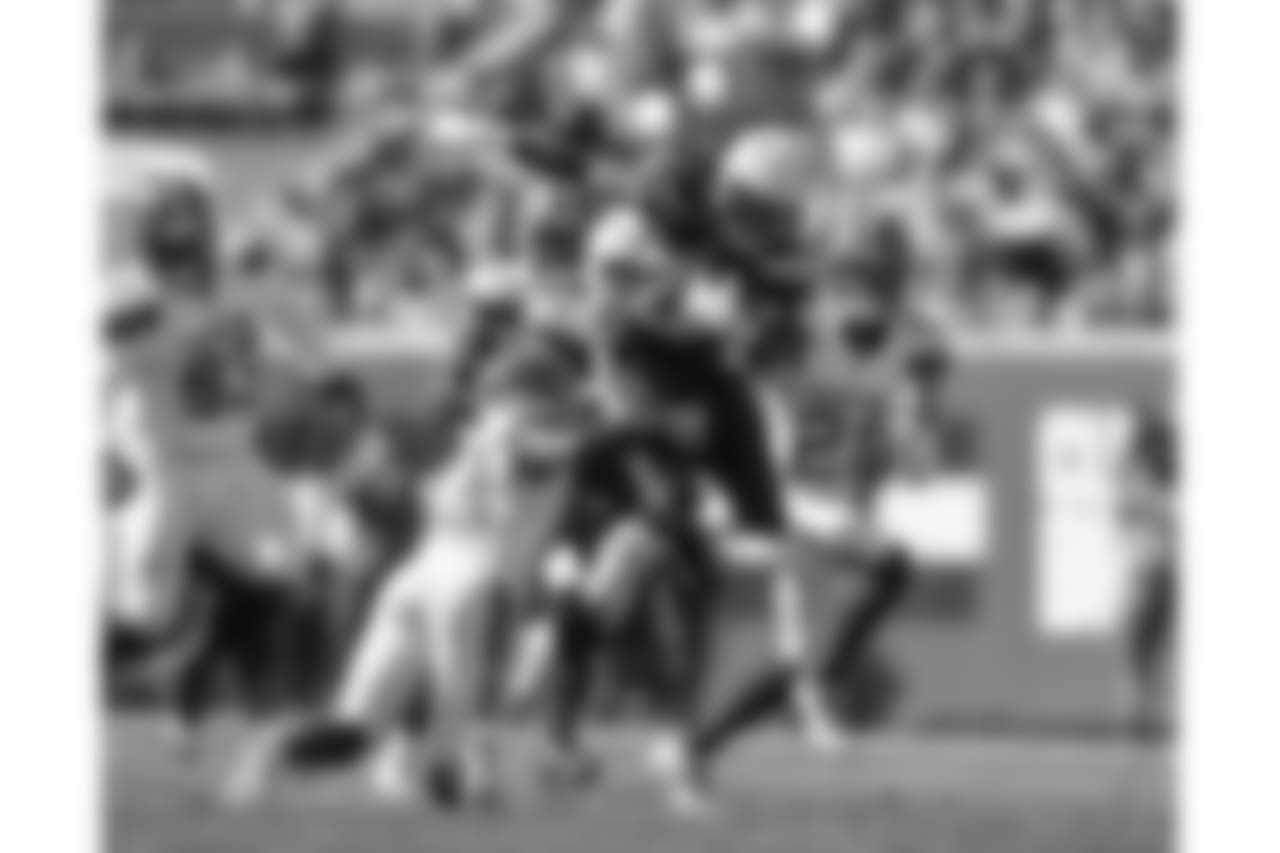 Melvin Gordon leaps over defenders to score the first touchdown of the game during the Week 6 matchup against the Browns.