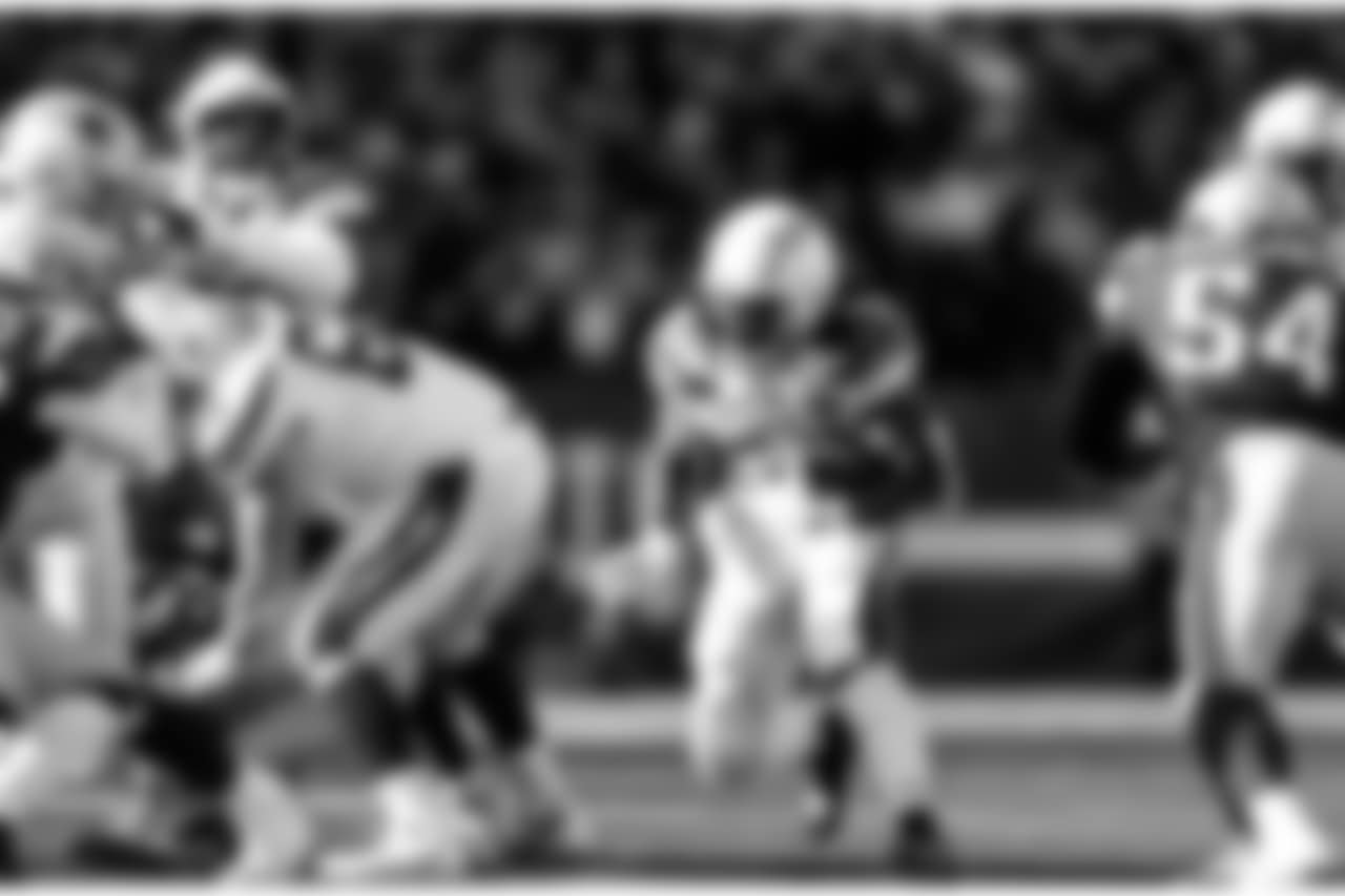 Melvin Gordon runs with the ball during the Divisional Round matchup against the New England Patriots at Gillette Stadium.