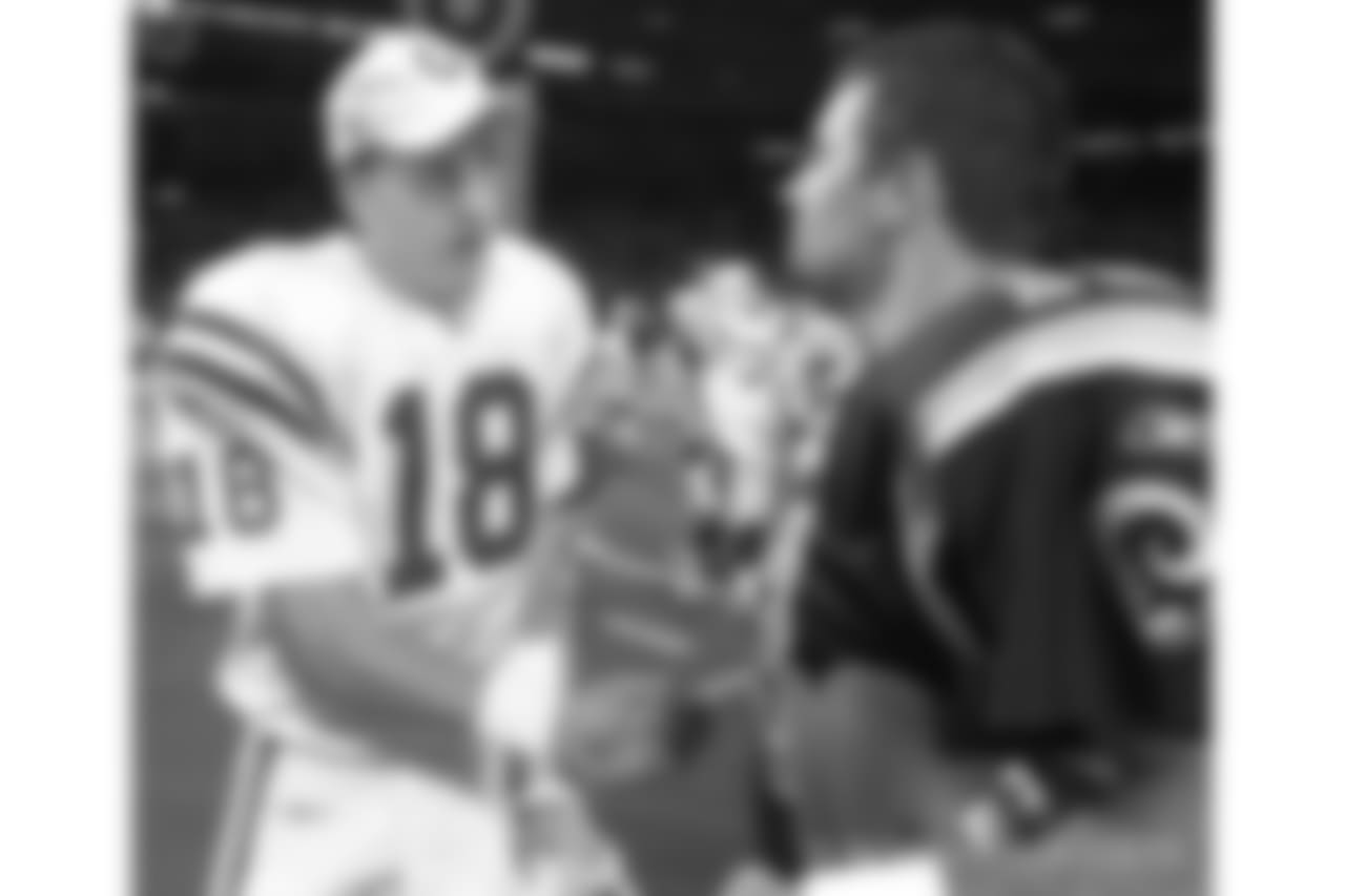 Indianapolis Colts quarterback Peyton Manning, left, congratulates St. Louis Rams quarterback Kurt Warner after Warner led his team to a 42-17 win and the NFC West title in St. Louis, Sunday, Dec. 30, 2001. (AP Photo/Charles Rex Arbogast)